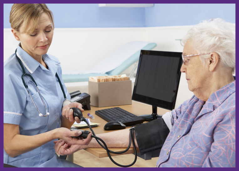 photo of a nurse taking the blood pressure of a senior woman sitting at a desk in a medical office - when you need to choose a nursing home, consider the medical services available
