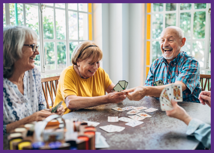 photo of four smiling seniors playing poker - when you need to choose a nursing home, consider the activities offered