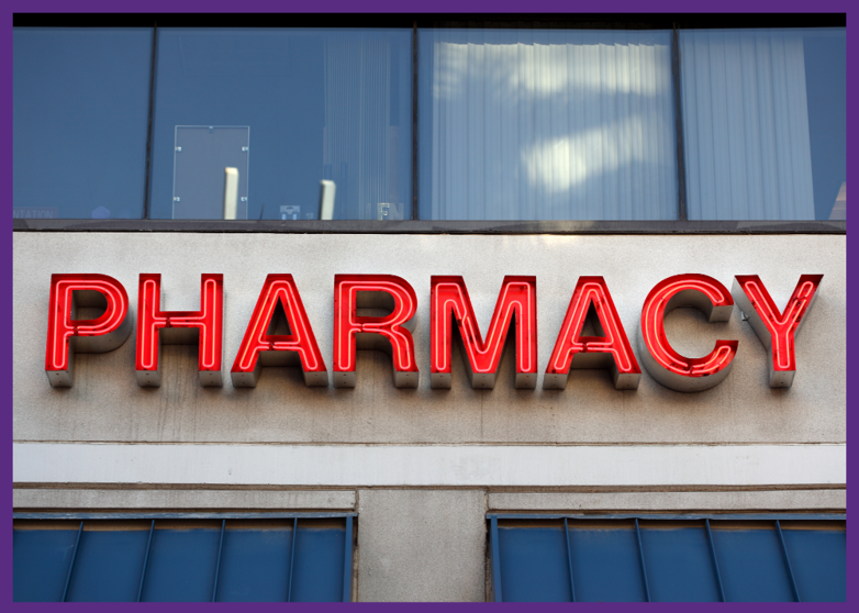 photo of the outside of a pharmacy with the word pharmacy written in neon - do your homework to reduce your risk of mistakes at the pharmacy