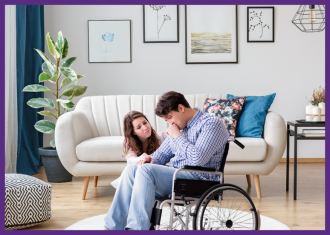 a young wife kneeling down to comfort her wheelchair-bound husband who is upset, in their living room