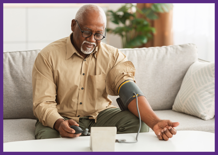 photo of a senior man sitting on a sofa, taking his blood pressure - monitoring your blood pressure can be part of getting medical care at home