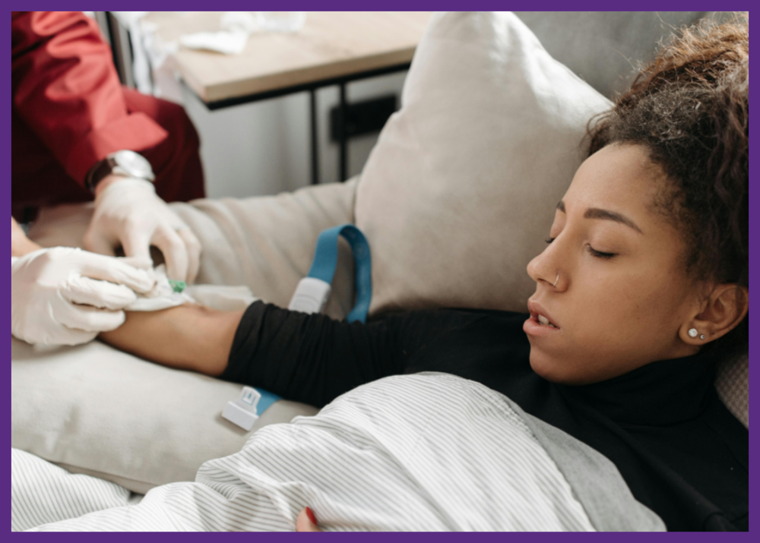 photo of a woman on a sofa at home, with a nurse putting an IV in her arm - make sure you understand home infusion therapy risks and rewards