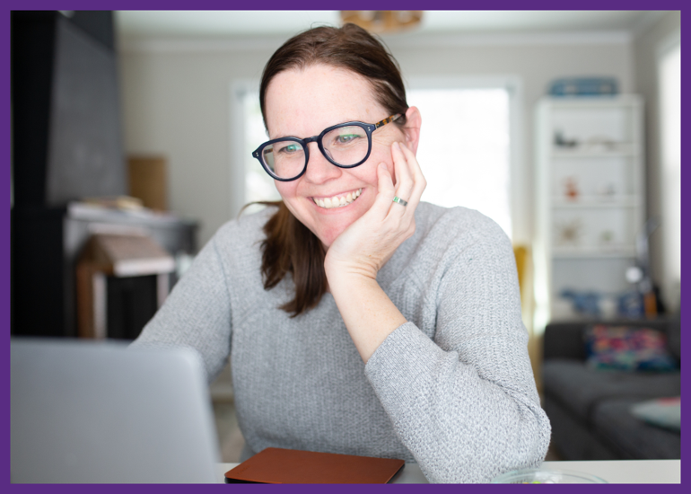 photo of a woman in her living room, sitting at a table, on a video call - Telenursing support for monitoring devices can help you manage the care of a loved one or yourself